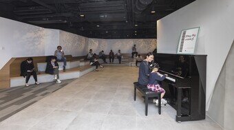 The open space in H6 CONET provides a piano for public enjoyment.